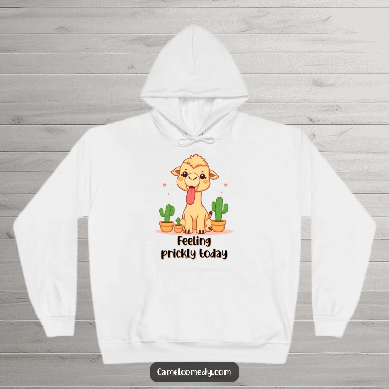 Funny hoodie showcasing a camel sticking its tongue out while juggling three small cacti, combining warmth with daring performance.