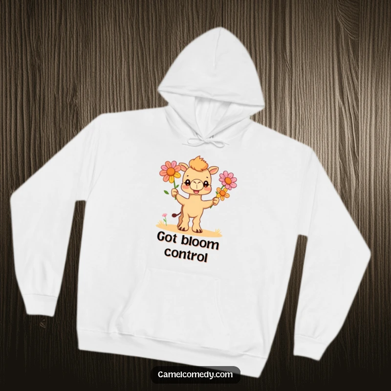 Funny and cozy hoodie showcasing a skilled camel character juggling a trio of bright desert flowers with a charmingly focused look.