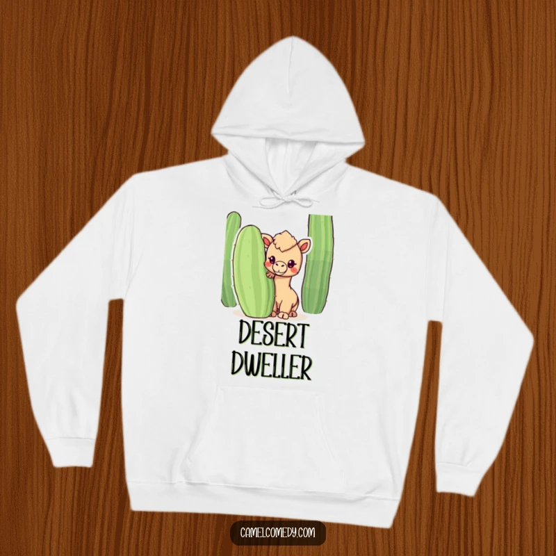 Funny hoodie featuring a kawaii camel peeking from behind a cactus, offering humorous warmth and desert-themed cuteness.