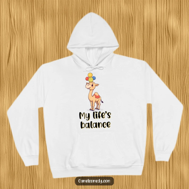 Funny, jovial camel juggling colorful balls on its hump, featured on a warm and humorous hoodie.